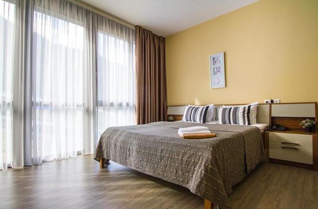 Двуспальная кровать в номере с панорамными окнами.